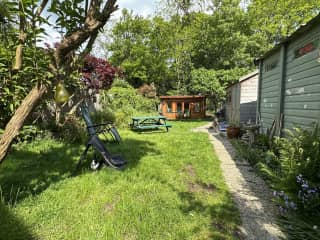 Back garden, with log cabin to rear