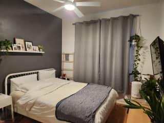 Main bedroom with Chromecast TV and ceiling fan.