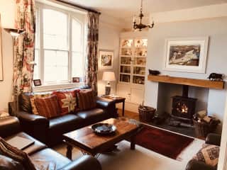 Sitting room with large TV and wood burner