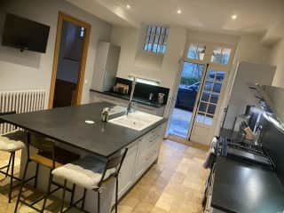 Kitchen with TV, walk in larder and large fridge freezer