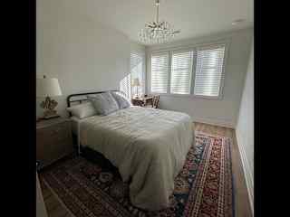 Queen bed with a dresser and closet space for hanging clothes