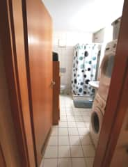 Bathroom with dryer and washing machine inside so no need to go outside the apartment for laundry