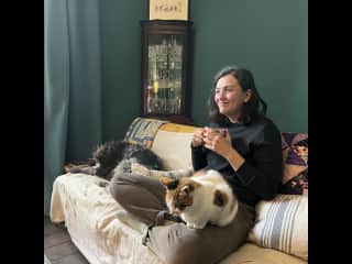 Gabi having coffee with two pets on a Trusted Housesitters sit