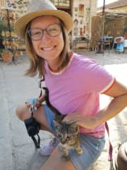 Hannah cuddling with a cat in Greece