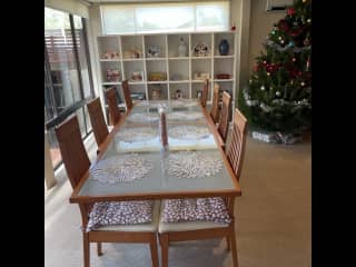 8 seater dining table with comfortable chairs next to kitchen.