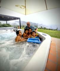 Denis having fun with the family in the hot tub.