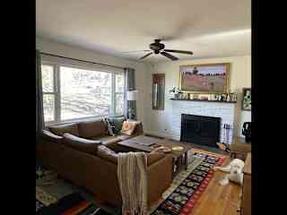 Living area with frame TV and fireplace