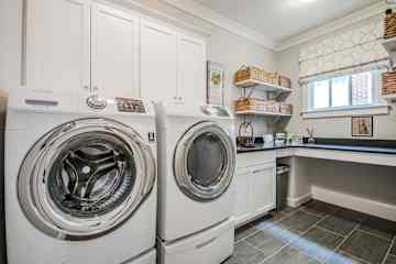 Laundry room on the main level, just off the kitchen and and mudroom.