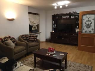 Spacious living room, with fireplace, piano, & TV.
