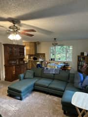 there is an open living and dining area with two couches and a four person round table