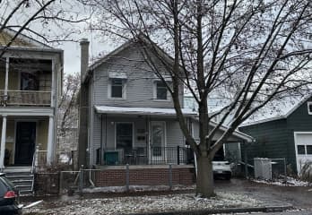 Front of house in the winter. Shows two-car carport