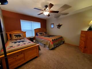 Second guest room with queen and twin beds, empty drawers and closet space.