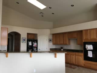 The large, well-equipped kitchen has a skylight and is open to the living room and dining room