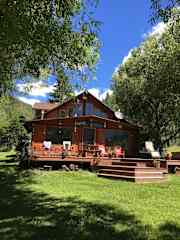 Front of cabin with deck and hot tub