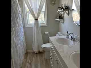 Upstairs bathroom. Double sink bathtub and shower.