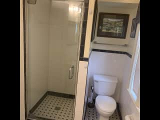 Guest bathroom with shower stall .  On first floor.