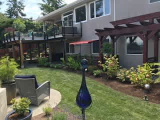 Back of home, raised patio and fenced Garden