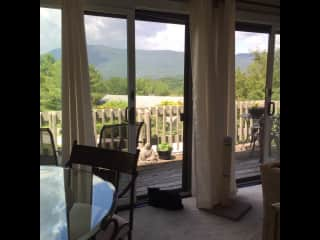 View from Living Room to Deck with Dining Area on Left