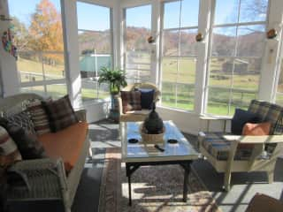 Screened porch at rear of house with views out over the valley.