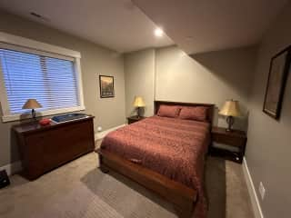 Guest room downstairs with queen bed and en-suite bathroom.