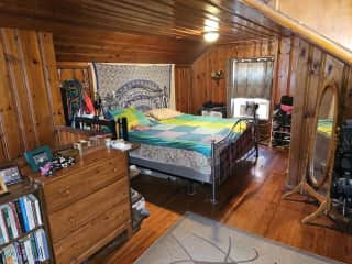 The upstairs master bedroom.  King size bed, window air conditioner.