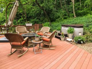 Large deck with two-person hot tub and gas firepit.