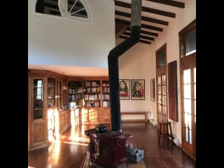 Wood stove is the heart of the living room / library space