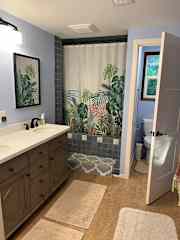 Bathroom with private WC, double sinks, bathtub and shower.