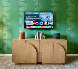 The guest room is also equipped with a smart TV including streaming services, high fidelity sound system, and clothing storage.