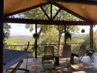 Screened in porch with views of rolling hills.