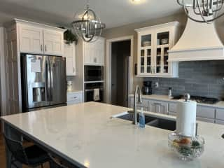 Kitchen: refrigerator, stove and island.