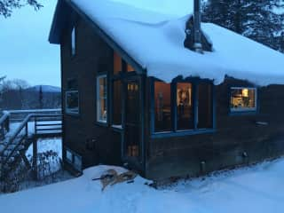 House in winter, with mountains beyond