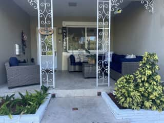 Front porch with sectional sofa. Front of the house faces east, so this is well shaded during the hot midday/evening sun.