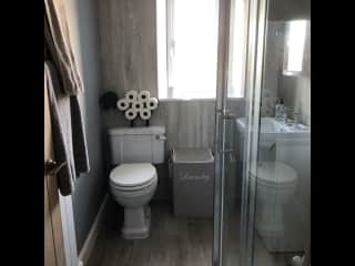 Our bathroom, with large rainfall shower, basin and toilet.