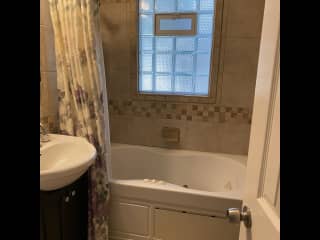Main bath with Jacuzzi/shower.