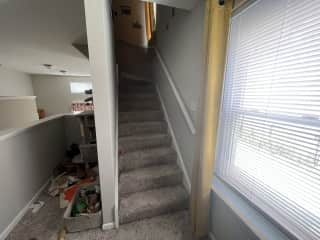 Nook where cat toys are supposed to be stored, and stairwell to upper level