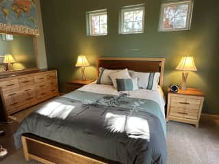 Guest bedroom downstairs where sitter can stay, adjacent to downstairs bathroom.