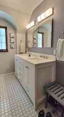 Remodeled bathroom has a walk-in shower.