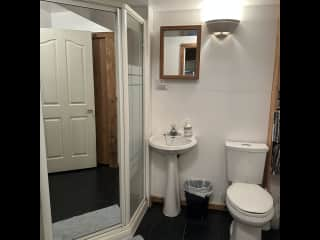 Three piece washroom with shower in basement.