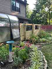 Backyard with new deck and lots of gardens!