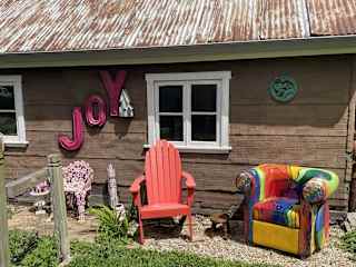 More outdoor seating near vegetable garden.