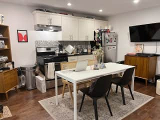 Another view of the kitchen living room save with TV (extends off of wall) and record player.