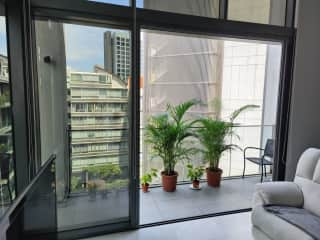 Living room windows fully retract, making the space flow out onto the balcony