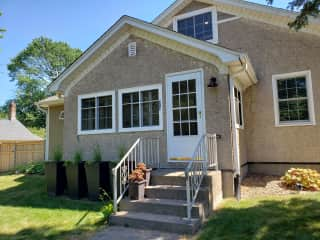 Front of the house features a nice indoor porch with couch and ceiling fan.