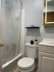 second bathroom with bath and shower.