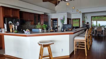 Kitchen outer counter. Main sink not visible but other side of stool.