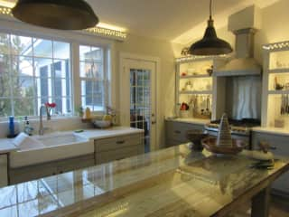 Kitchen with dining area and screened porch entry.