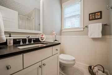 Guest bathroom has a bathtub with shower.