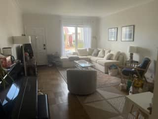 Living room complete with smart tv and upright piano. Great couch for reading (little reading light in the corner) and watching shows!