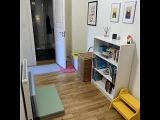 Litter box and laundry basket in the corner, and a little reading area with lots of kids books (English and Swedish)